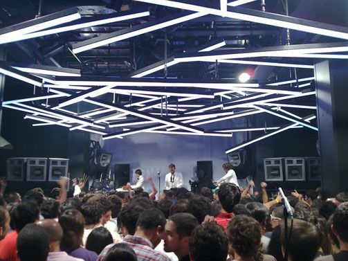 Packed club with vibrant lighting design and energetic atmosphere