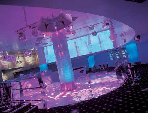 Stylish nightclub interior with purple neon lights and modern seating