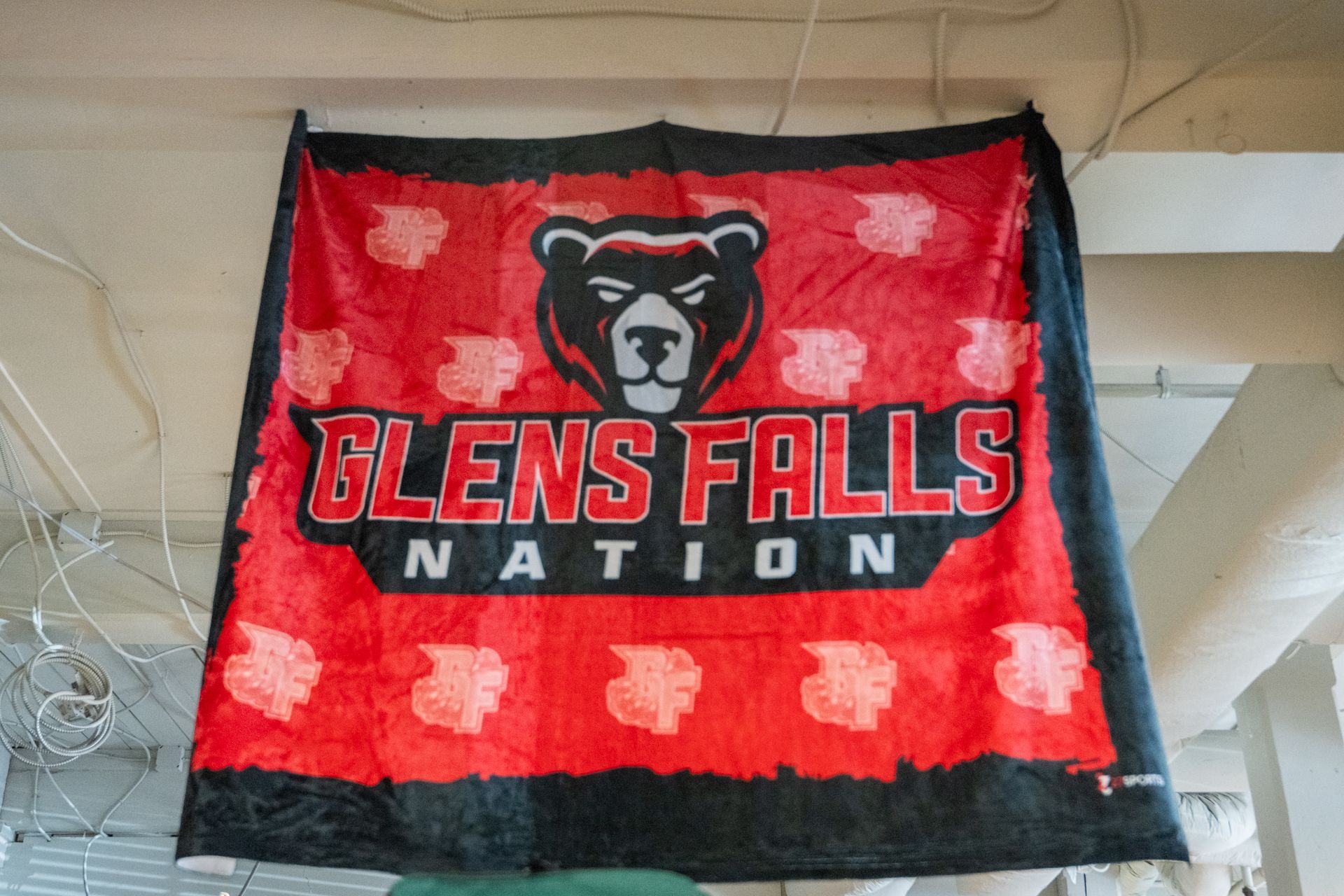 A glens falls nation flag is hanging from the ceiling.