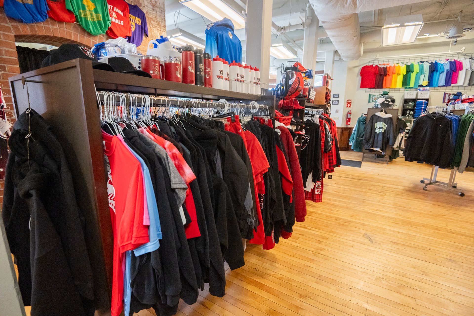 A store filled with lots of clothes hanging on racks.