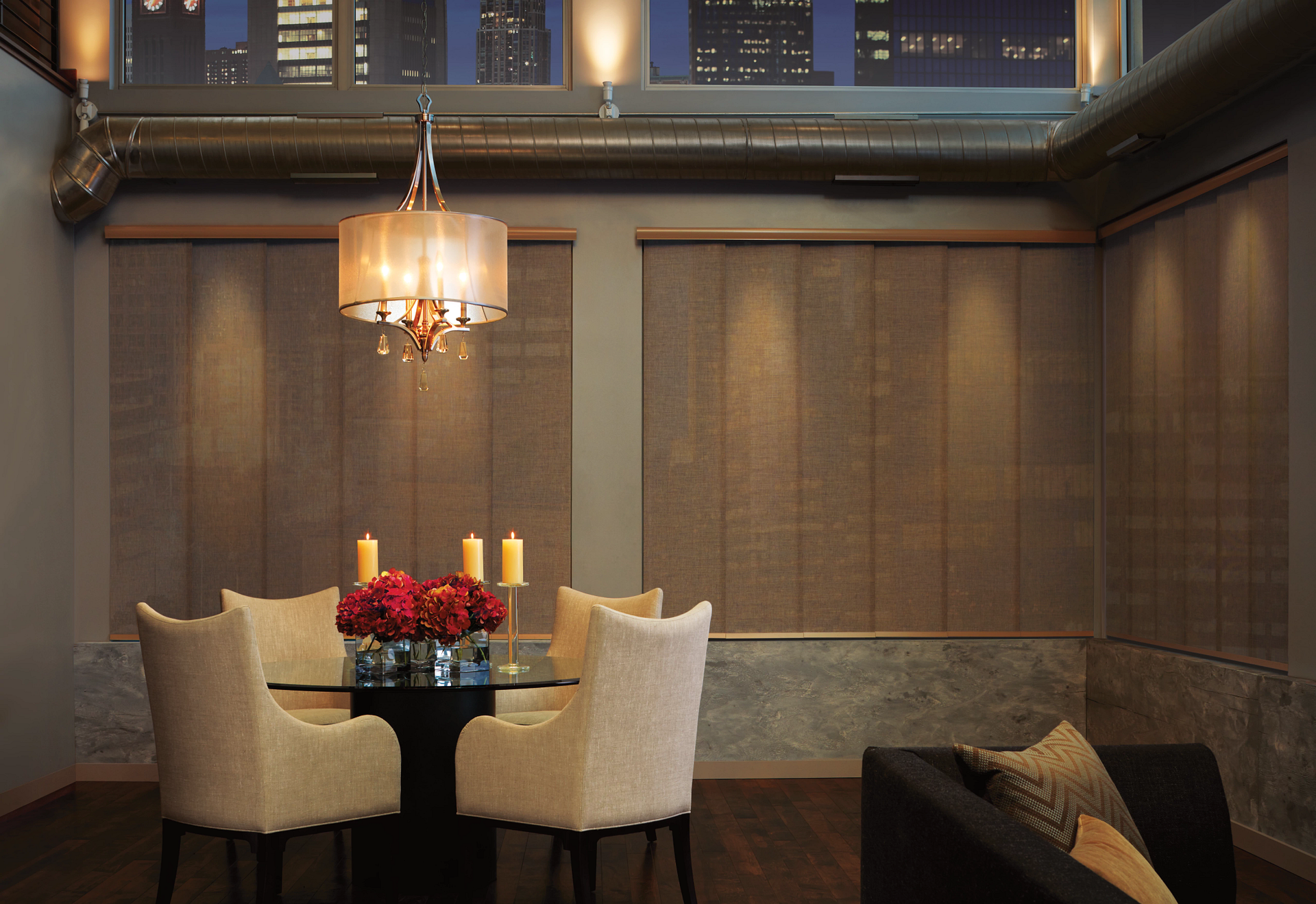 A dining room with a table and chairs and a chandelier