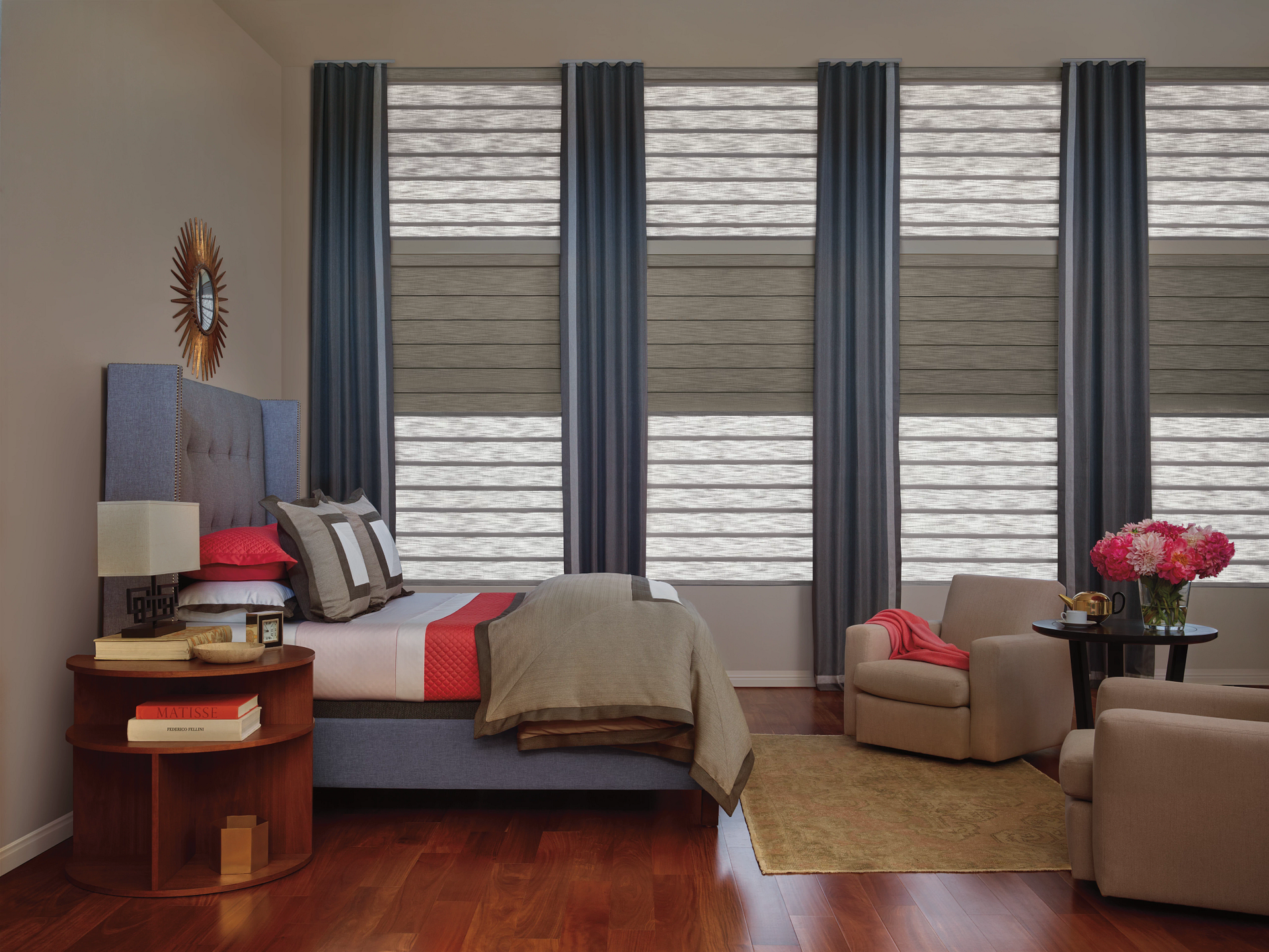 A bedroom with a large bed and lots of windows