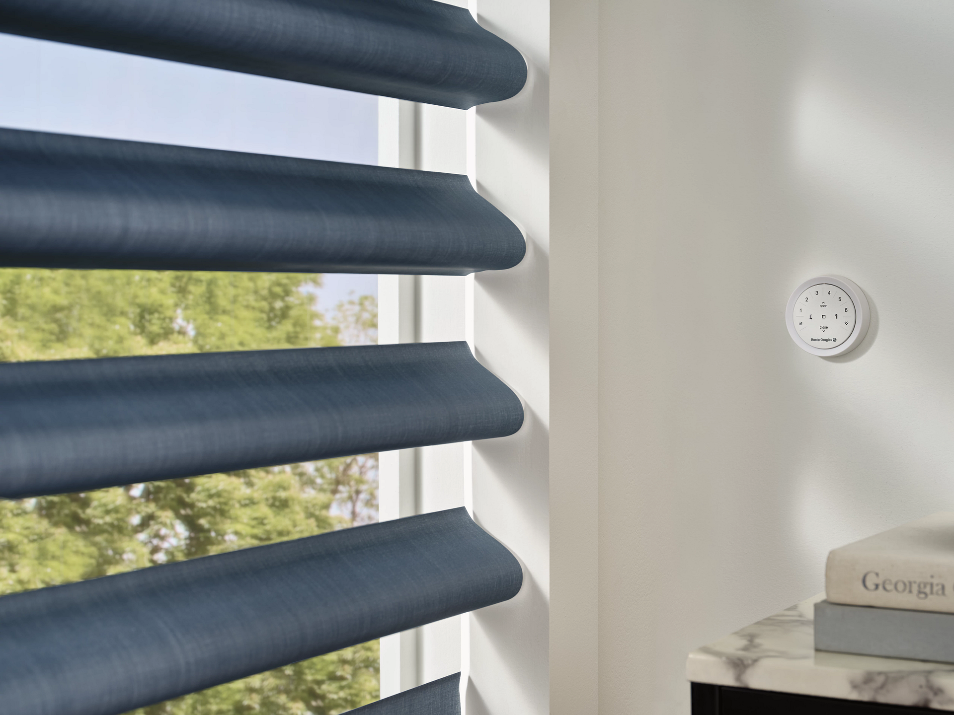A window with blue blinds and a clock on the wall
