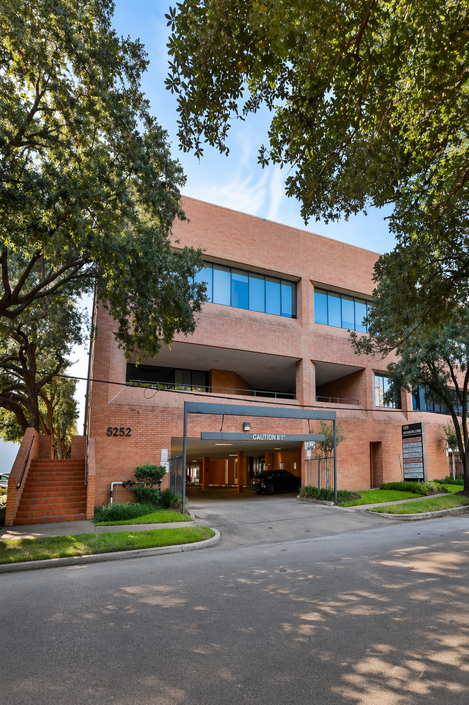 Tree-lined walkway leading to the 5252 Westchester Street office building