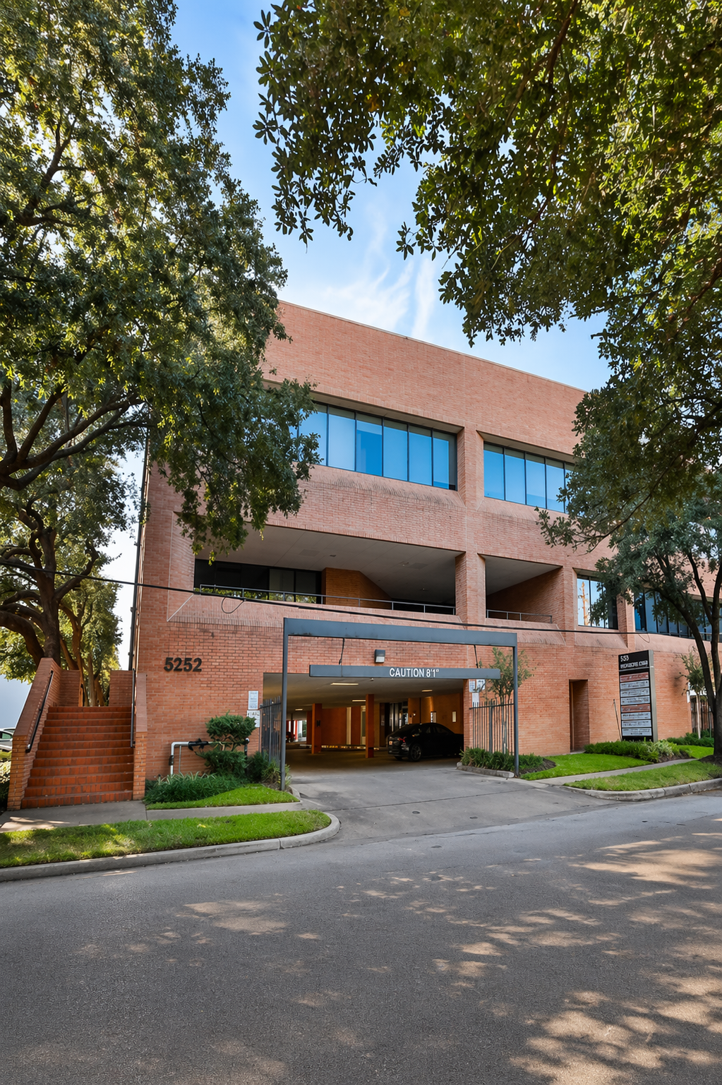 Tree-lined walkway leading to the 5252 Westchester Street office building