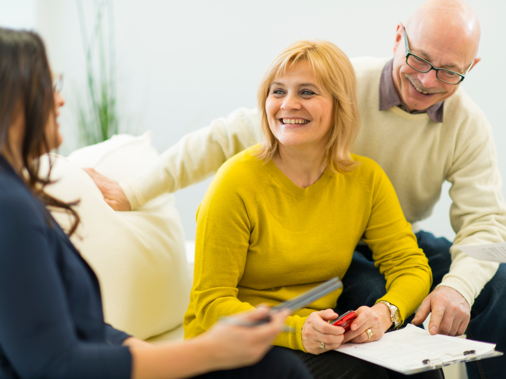 Couple stitting discussing insurance plans— St Michael, MN — EMEX Benefits Systems