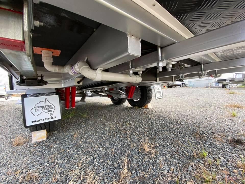 The Underside of a Trailer is Shown in a Gravel Lot — J & D Caravans In Tamaree, QLD