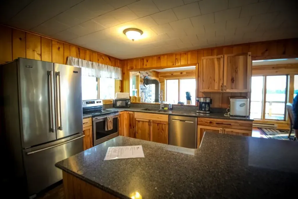 A kitchen with stainless steel appliances and granite counter tops