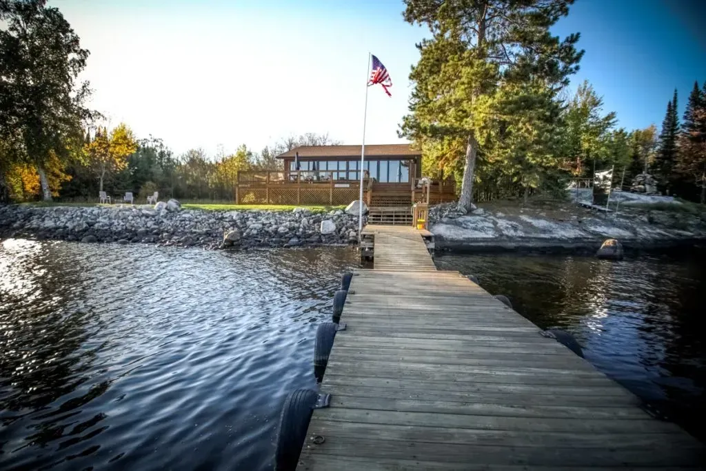 A wooden dock with an american flag on top of it