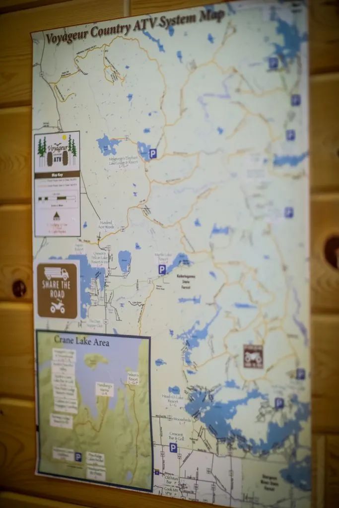 A map is hanging on a wooden wall.