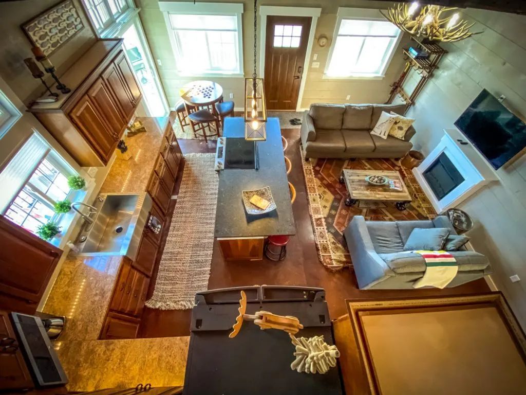 An aerial view of a living room filled with furniture and a fireplace.