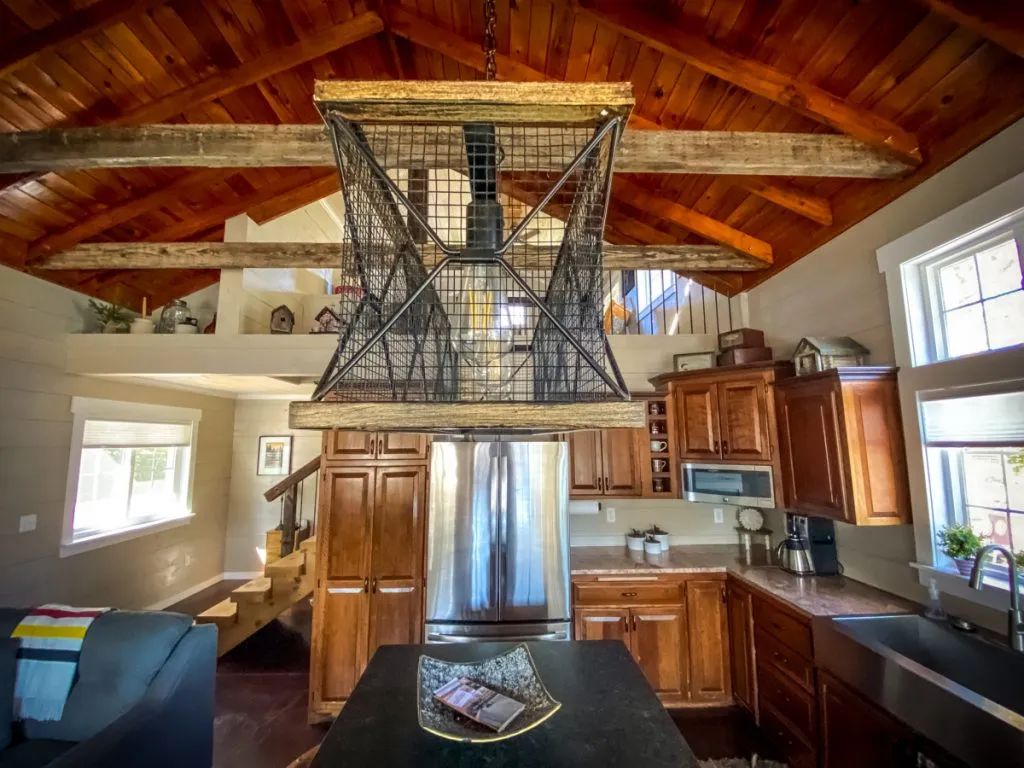 A kitchen with wooden cabinets and a stainless steel refrigerator.