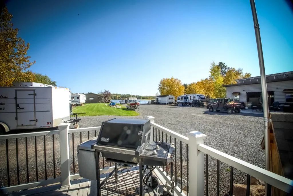 A grill is sitting on a deck in a parking lot.
