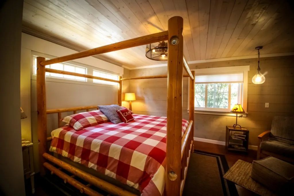 A bedroom with a four poster bed and a window