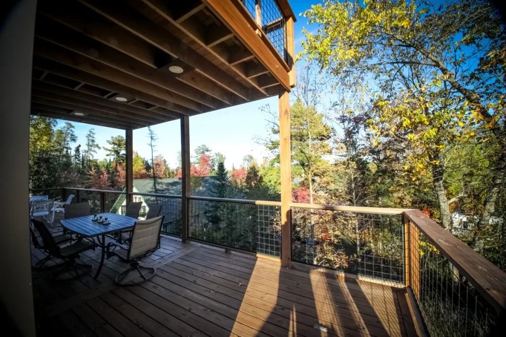 A wooden deck with a table and chairs on it