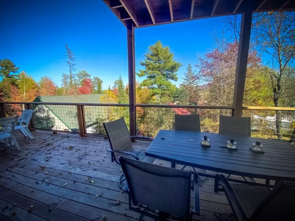 There is a table and chairs on the deck.