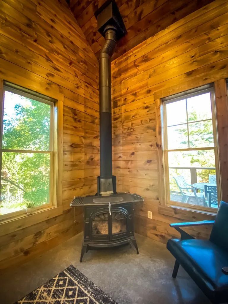 There is a wood stove in the corner of the room.