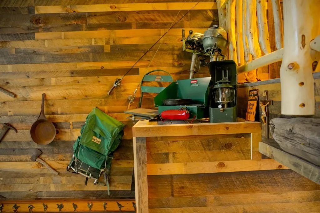 A wooden wall with a table and a backpack on it.
