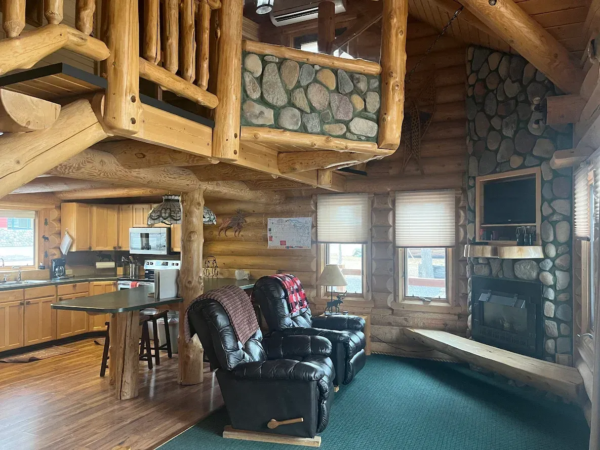 An aerial view of a log cabin with a fireplace