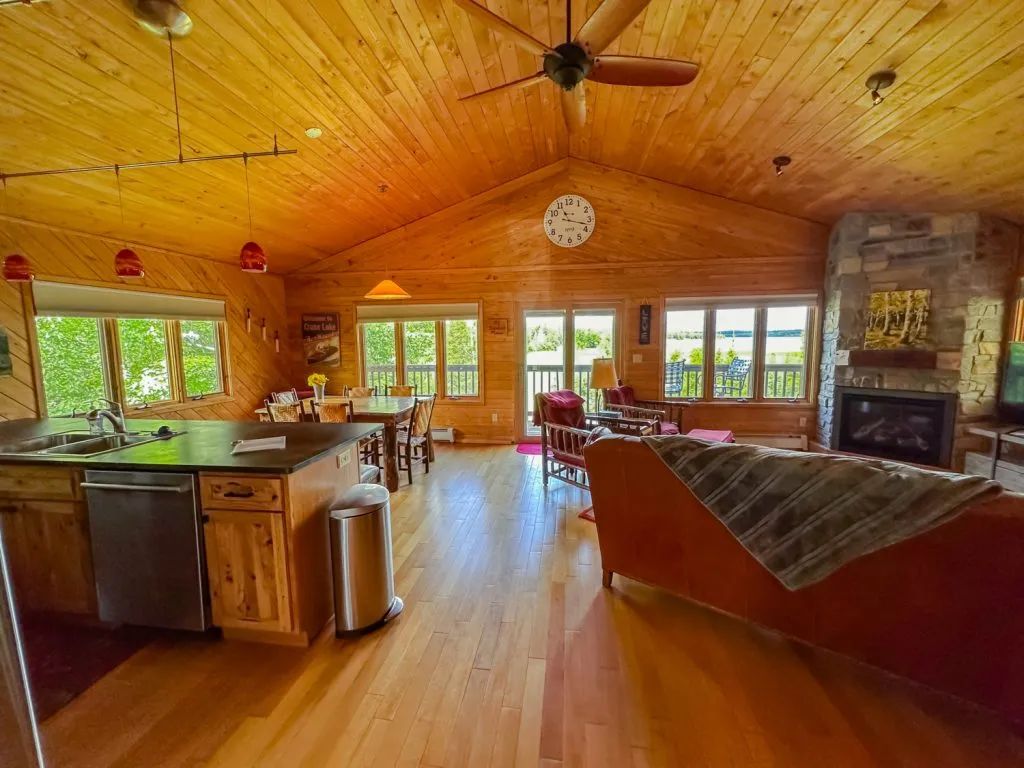 A large wooden house with a lot of windows and a ceiling fan.