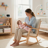 A person sits in a wooden rocking chair in a nursery, bottle-feeding a baby dressed in pink.