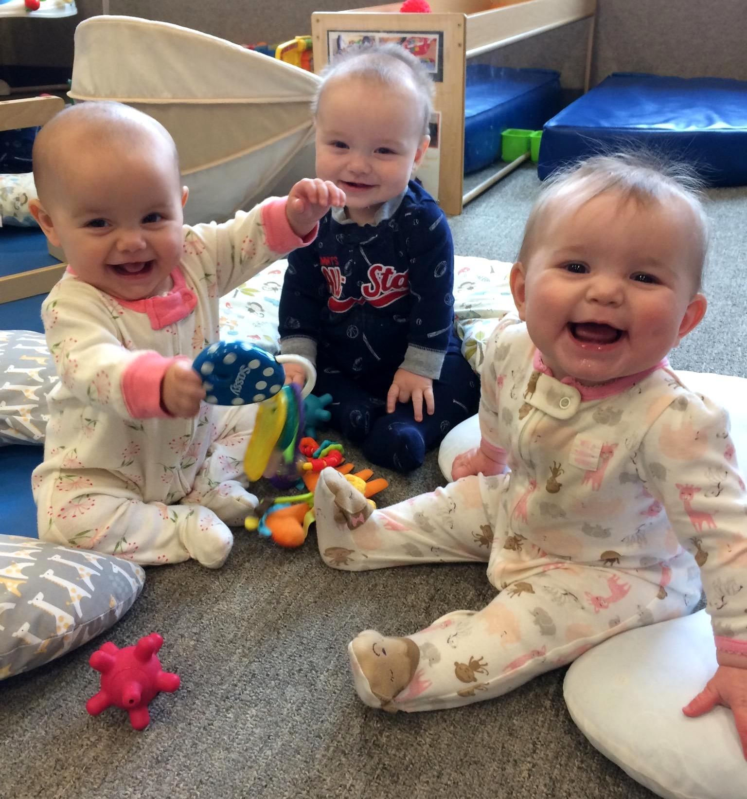 Three babies smiling