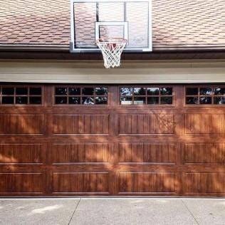 Wooden garage with a basketball hoop mounted above the door.