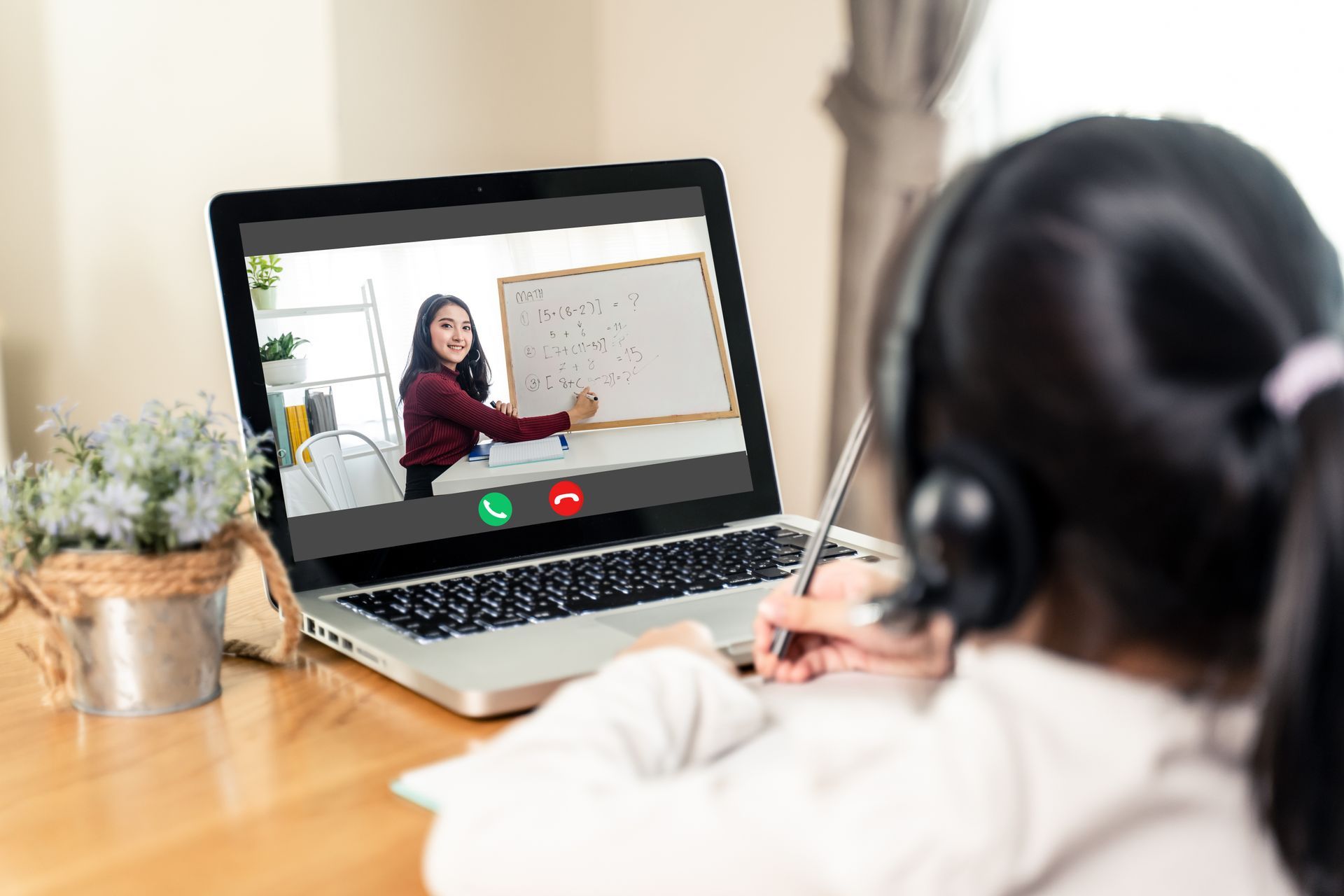 little girl listening in online tutorial program