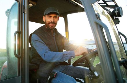 Agricultural tractor expert holding the steering wheel Agricultural tractor expert holding the steering wheel