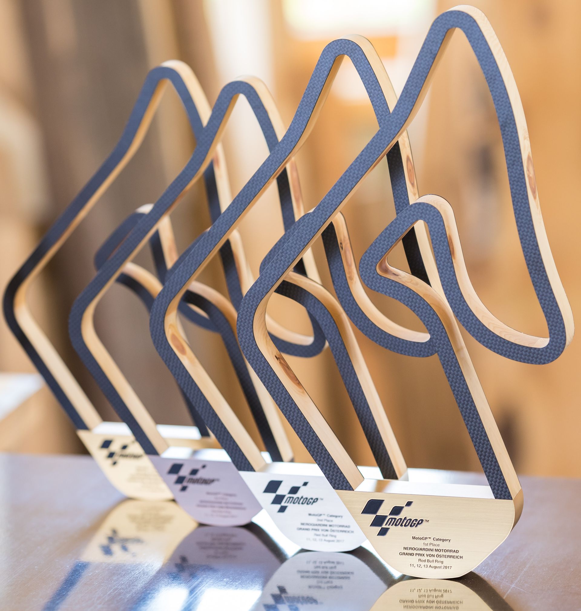 Ein Stapel Trophäen auf einem Tisch, auf einer steht „GP“