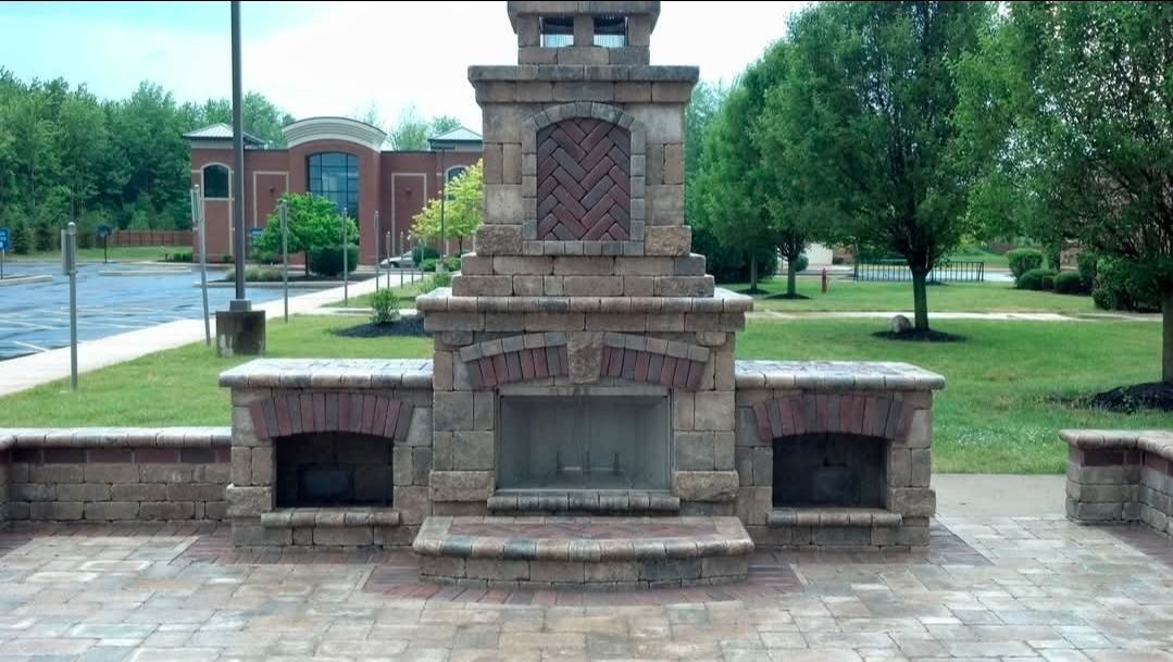 Brick memorial fountain with three stone basins in a park plaza