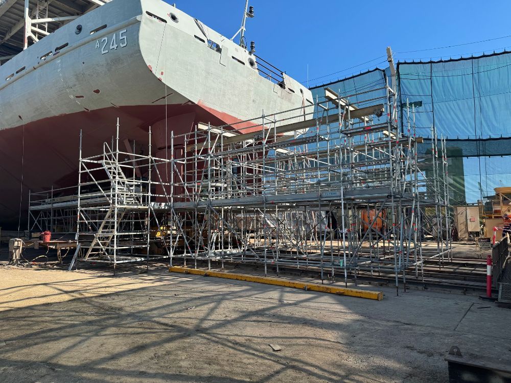 A large ship is being built in a dock with scaffolding around it — T & T Scaffolding in Gordonvale, QLD