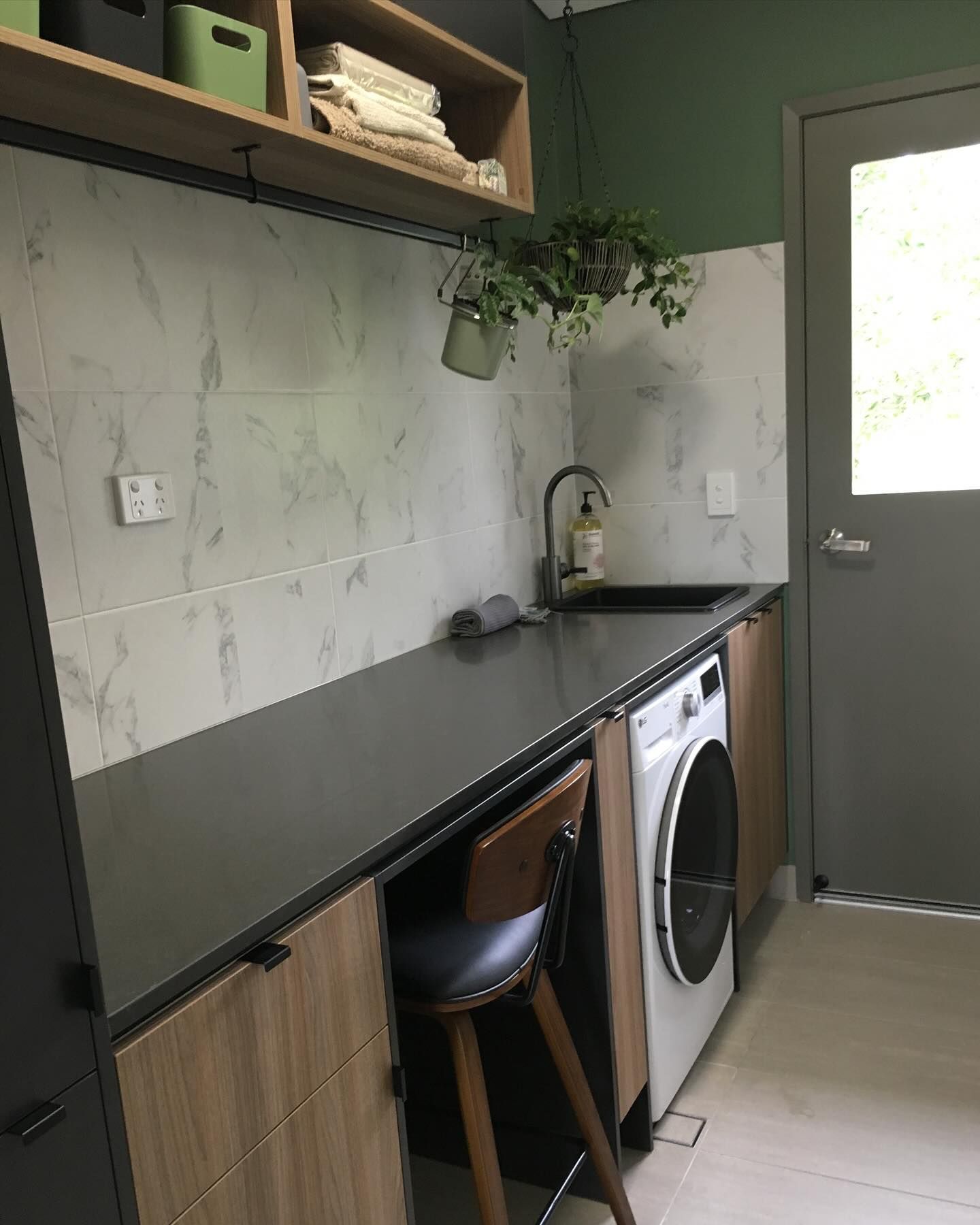 Laundry Room With Marble Tile Backsplash, Dark Countertop, Washing Machine — Akyrah Kitchens in Gympie, QLD