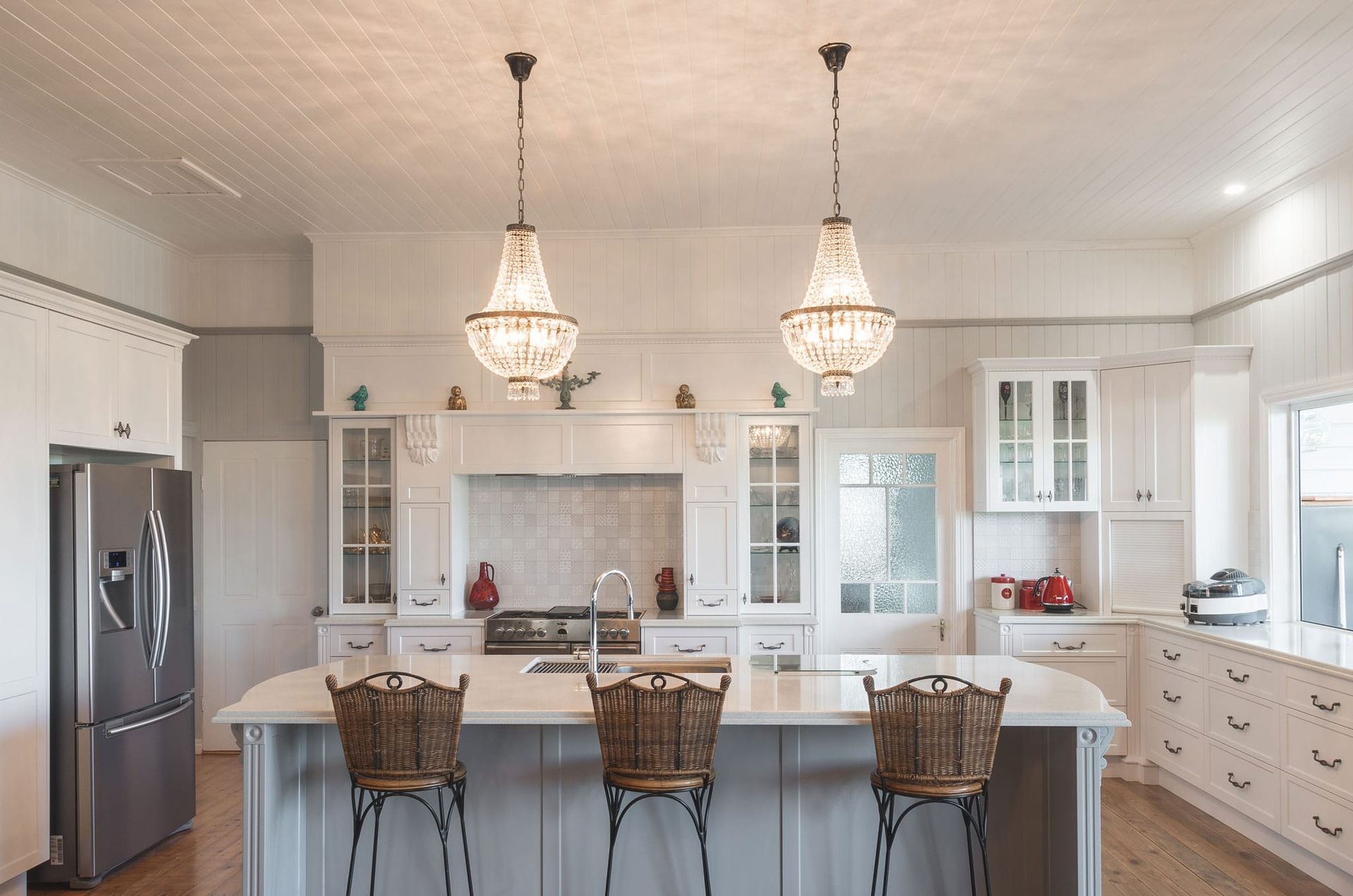 Modern Kitchen With White Cabinets, Gray Countertops, and Wood Island With Bar Stools — Akyrah Kitchens in Gympie, QLD