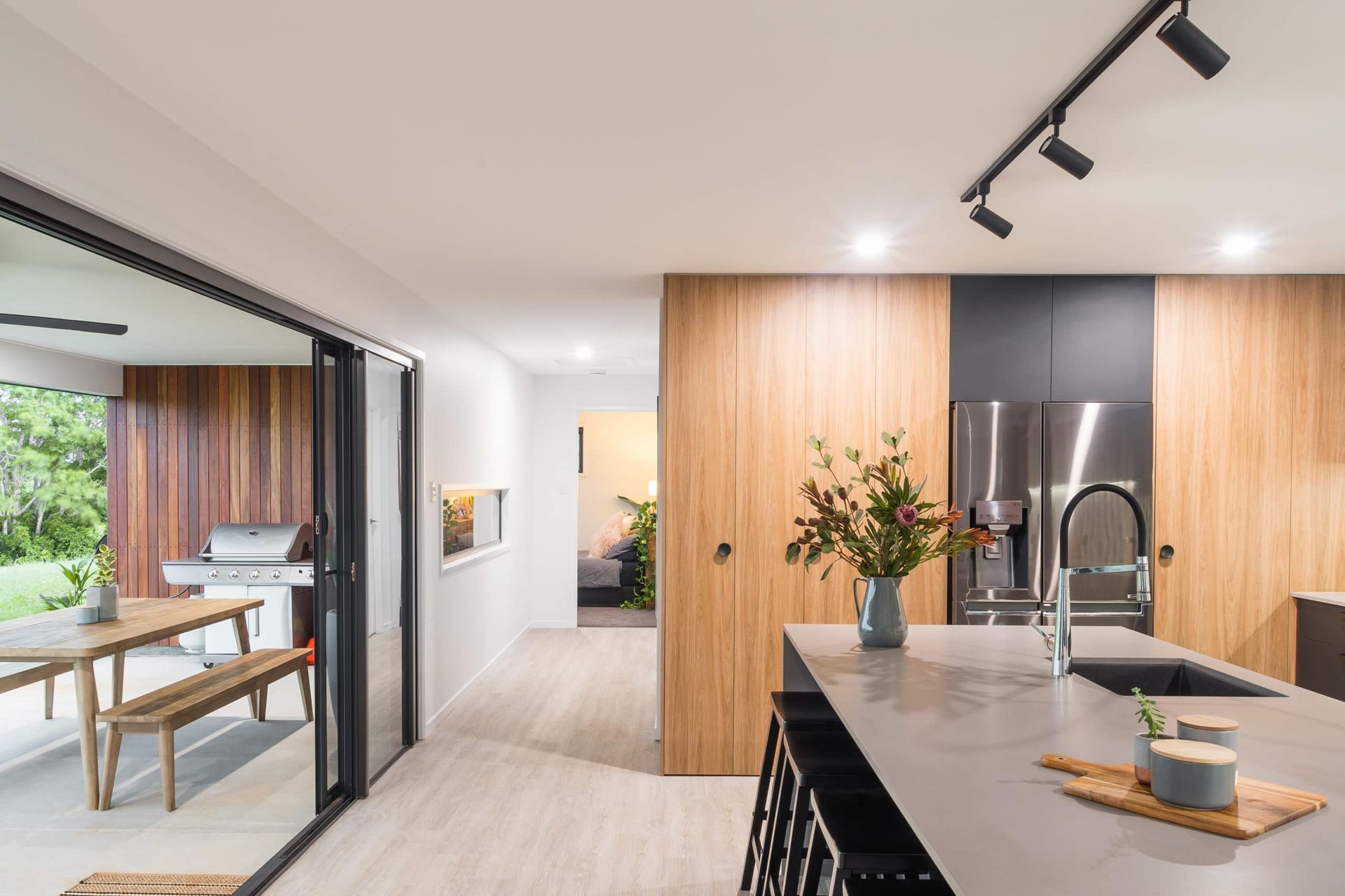 Modern Kitchen With Light Wood Cabinets, Gray Countertops, and a Sliding Glass Door  — Akyrah Kitchens in Gympie, QLD