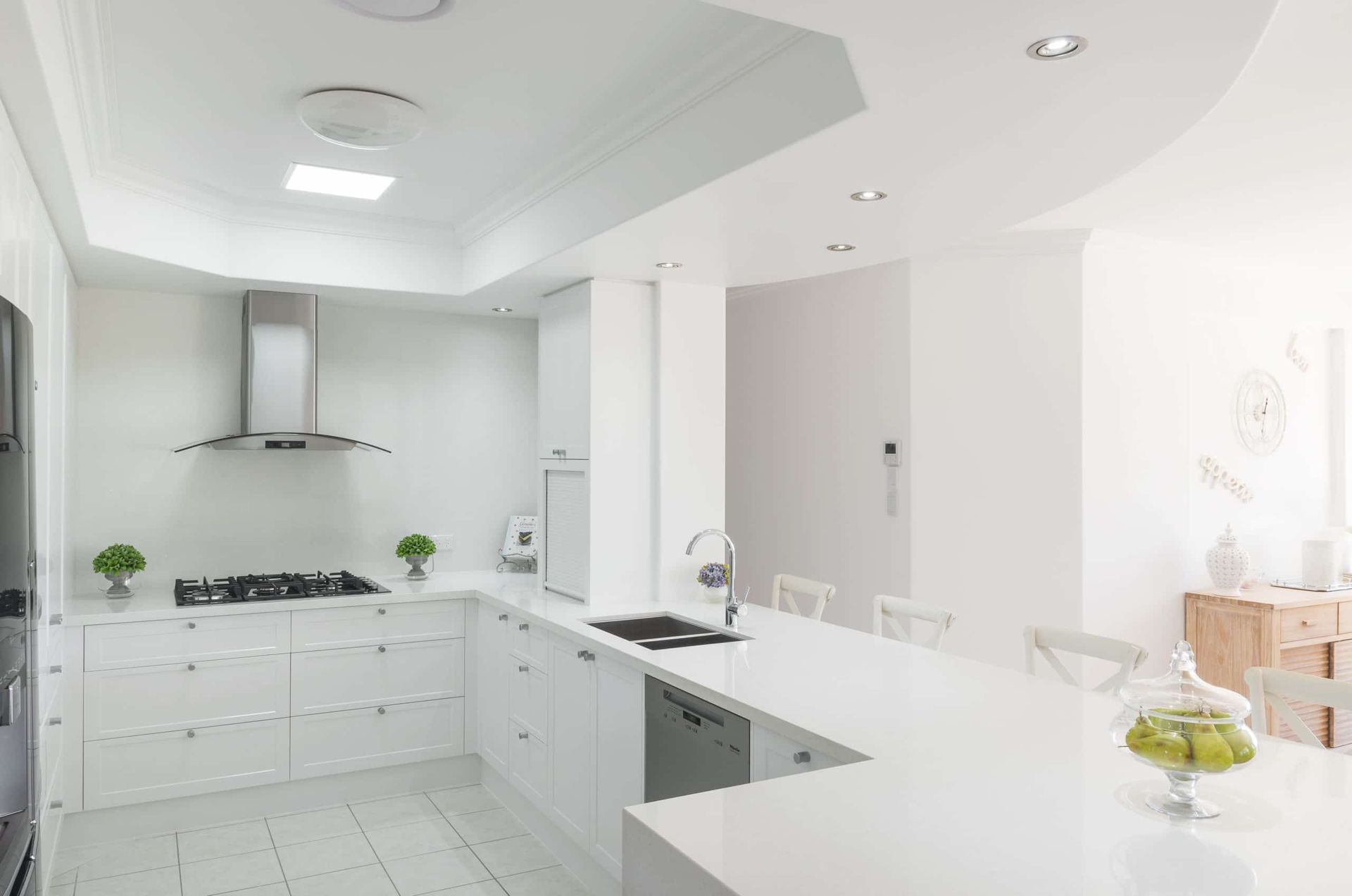 White Kitchen With Stainless Steel Appliances, White Cabinets, and a Breakfast Bar — Akyrah Kitchens in Gympie, QLD