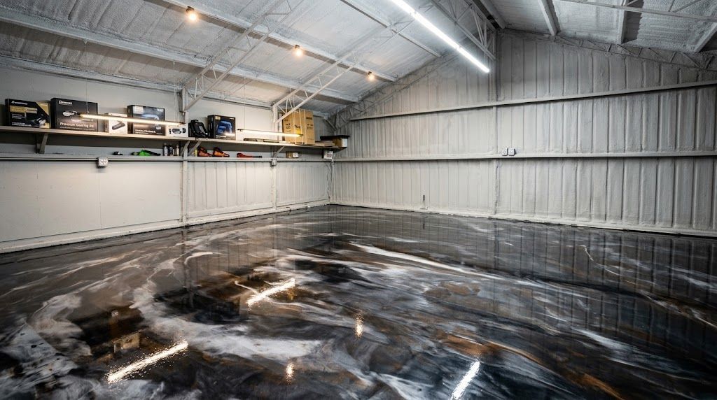 Empty warehouse interior with reflective black floor covering and overhead fluorescent lights