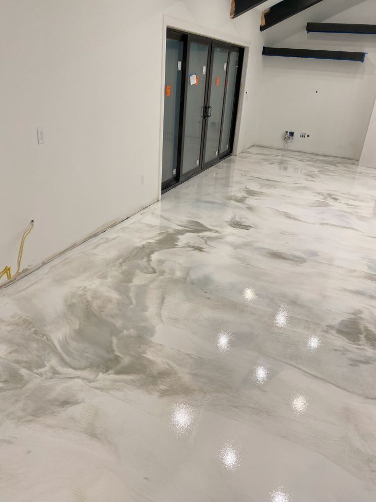 Glossy white marble floor in a modern empty room with glass doors and bright reflections