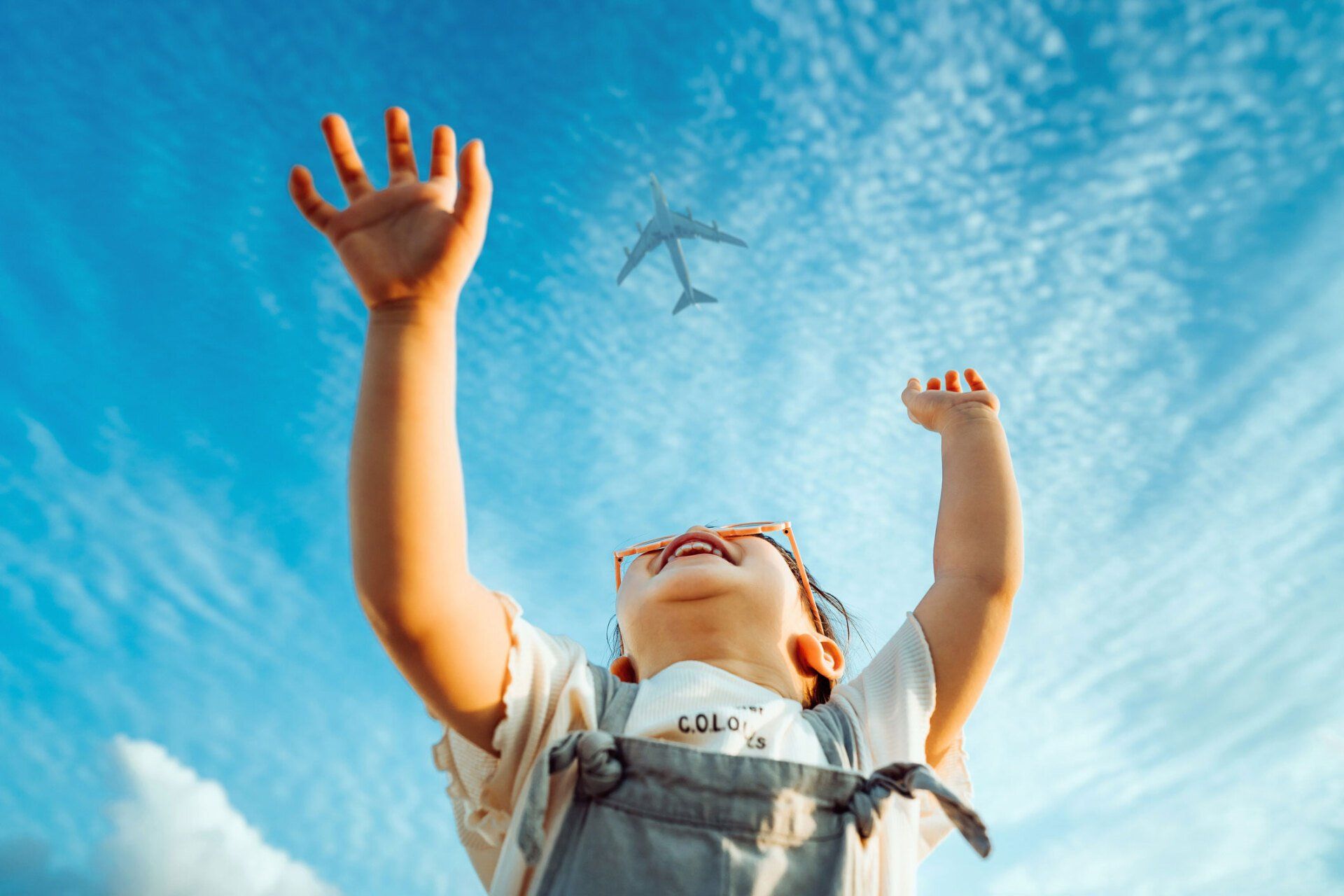 Kid looking to the sky with Jet in the background.