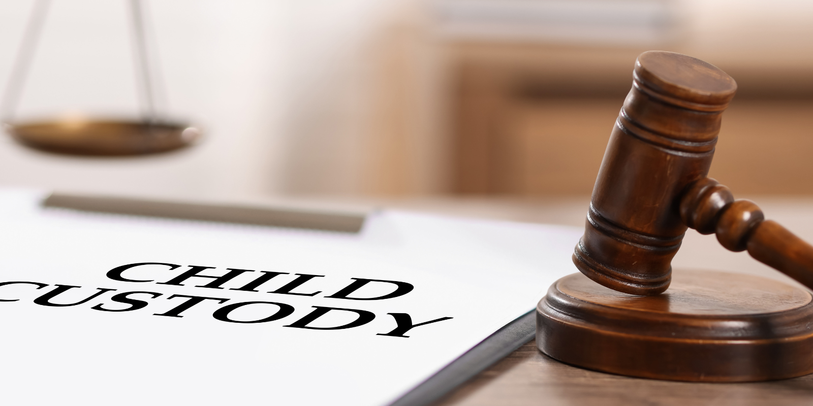 Judges gavel on legal documents with blurred scales in the background