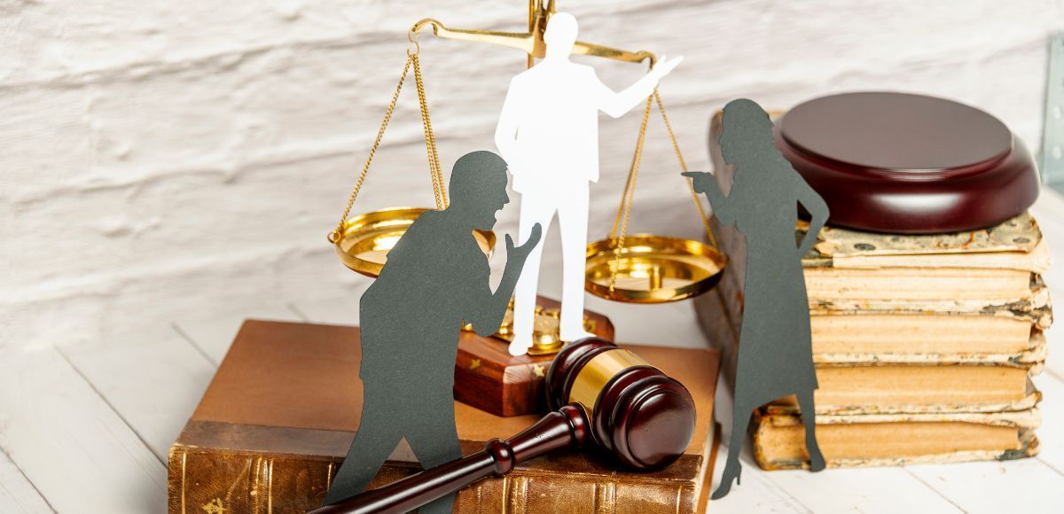 Legal scales, gavel, and people with judge talking about divorce and separation options