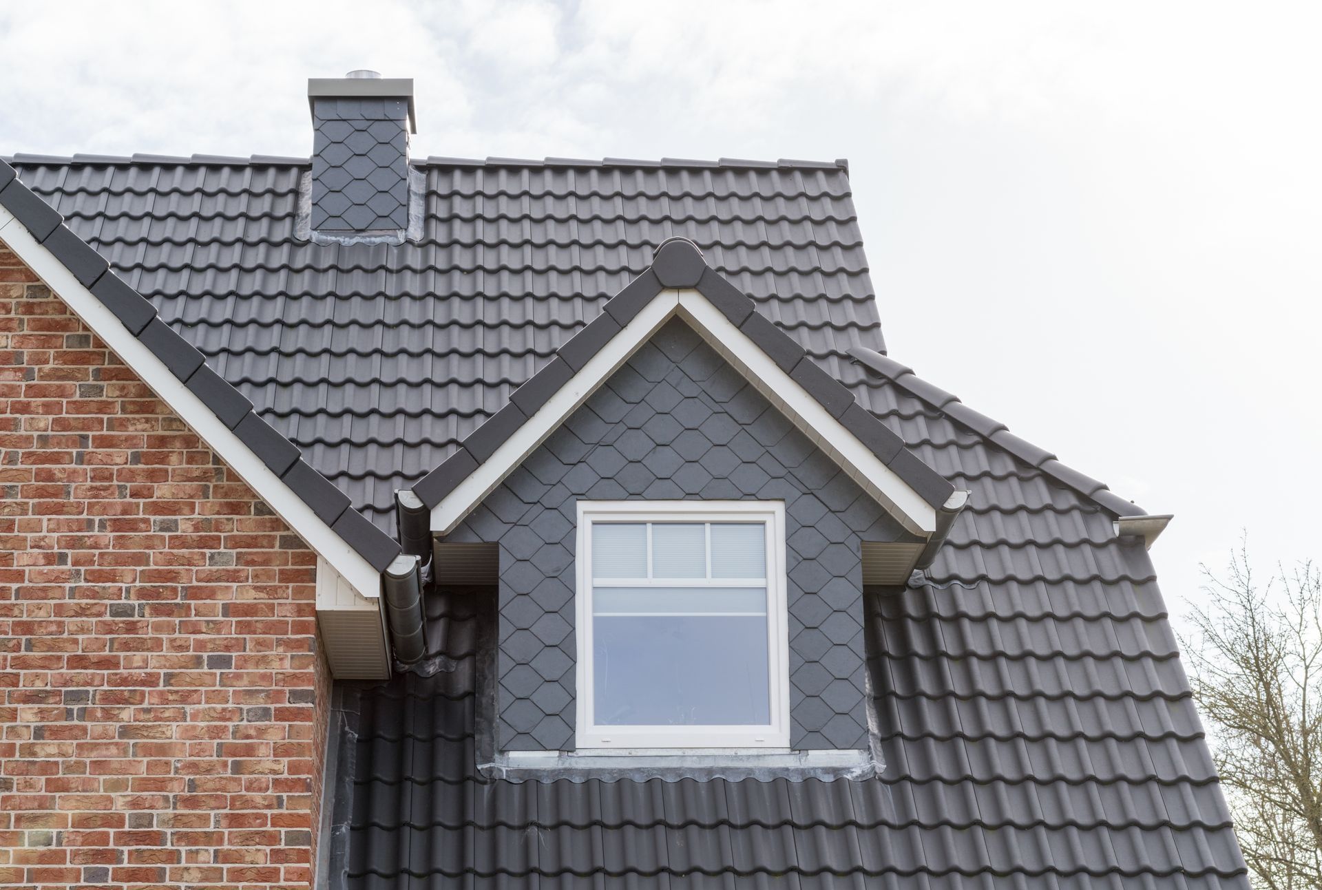 Roof of a home with elegant window showcasing quality work by a trusted residential roofer. Roof of a home with elegant window showcasing quality work by a trusted residential roofer.