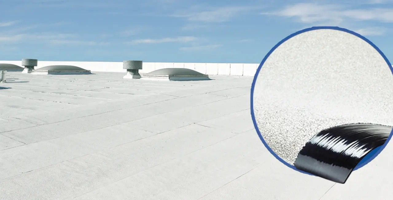 White rooftop with small vents, plus a magnified inset showing a black brush applying coating to a textured surface