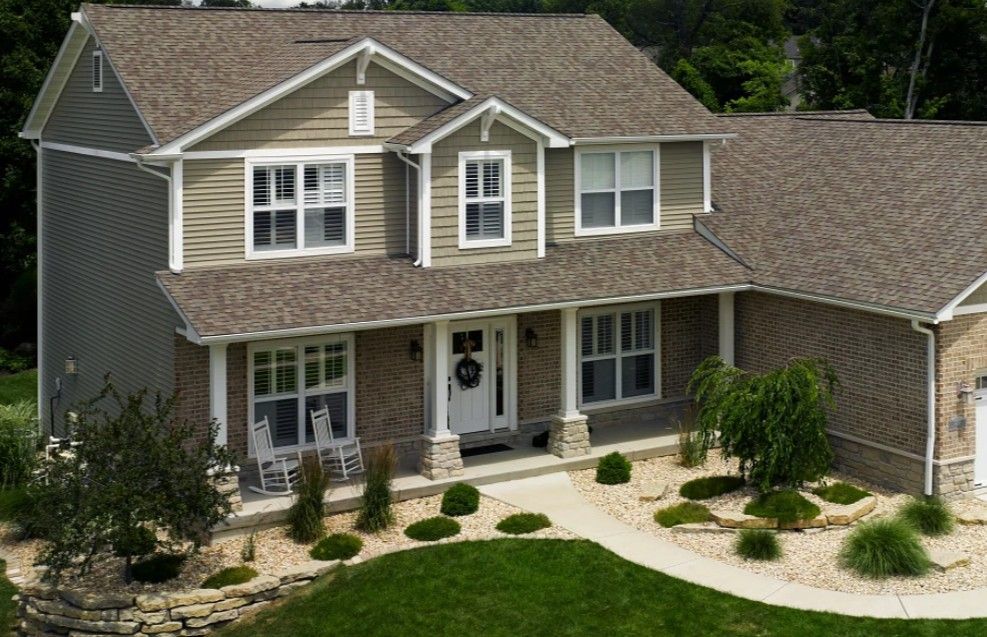 Overhead view of a house with a newly installed gray shingle roof.