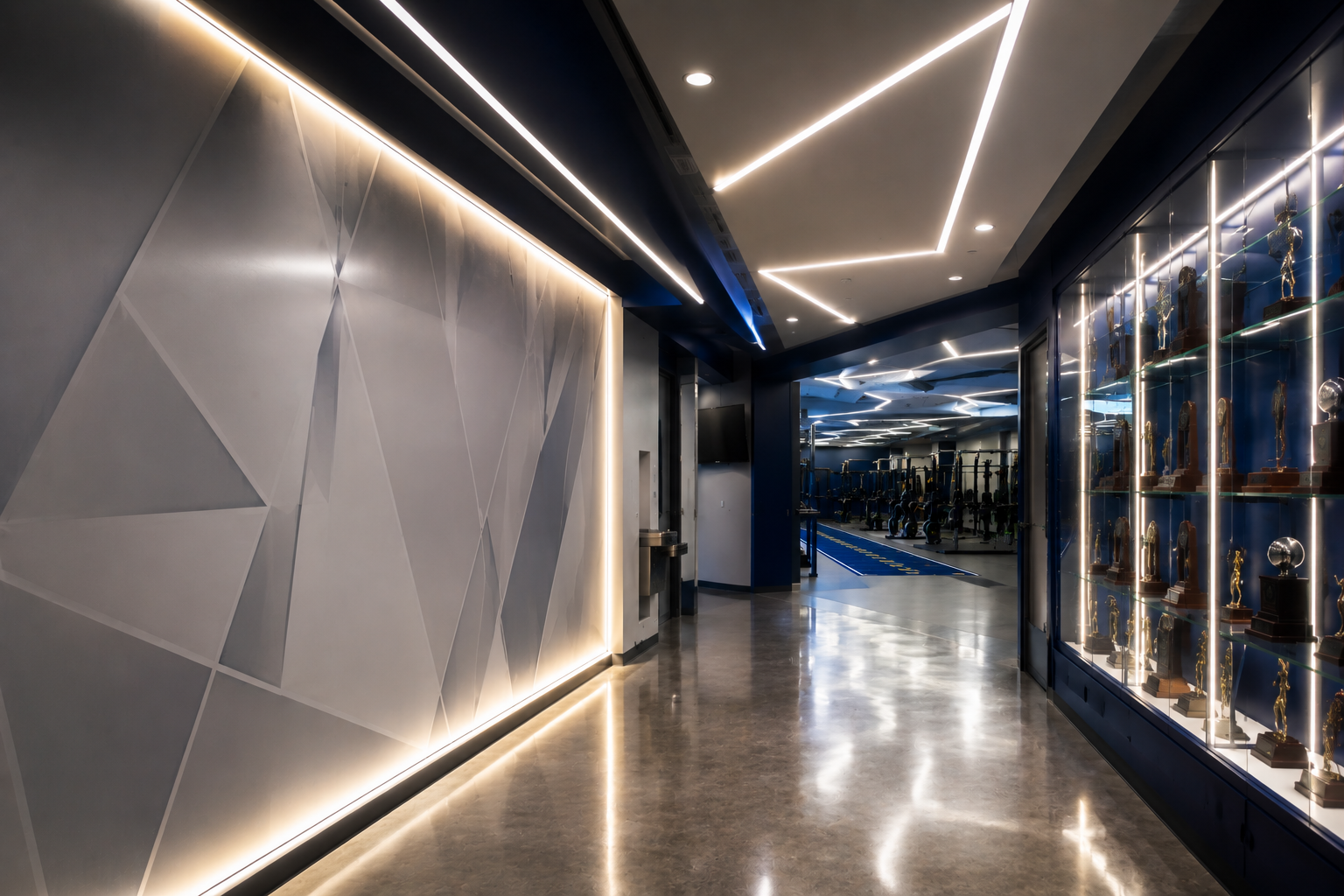 Modern hallway with geometric wall panels, warm LED lighting, and reflective glass display cabinets