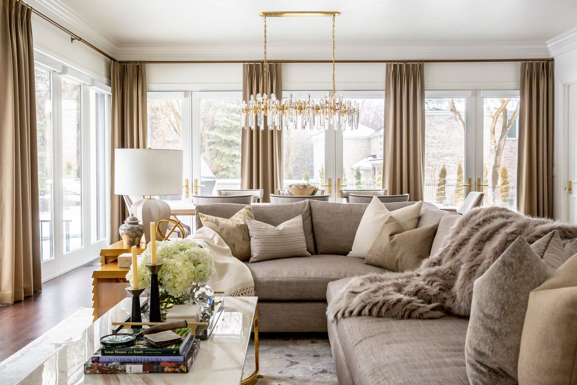 Custom drapery framing large windows in luxury great room