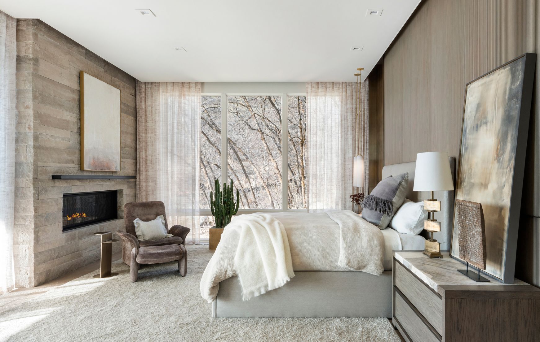 Custom drapery and layered window treatments in luxury primary bedroom