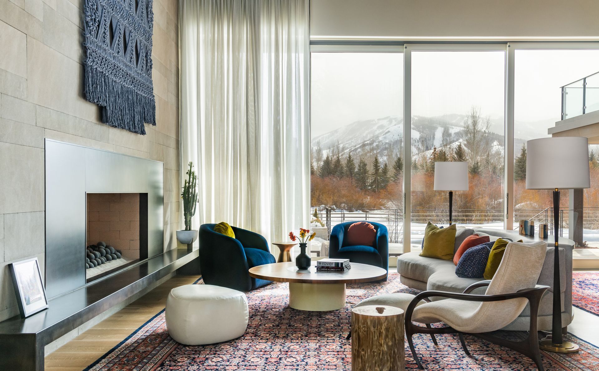 Custom sheer drapery and motorized shades in luxury mountain living room