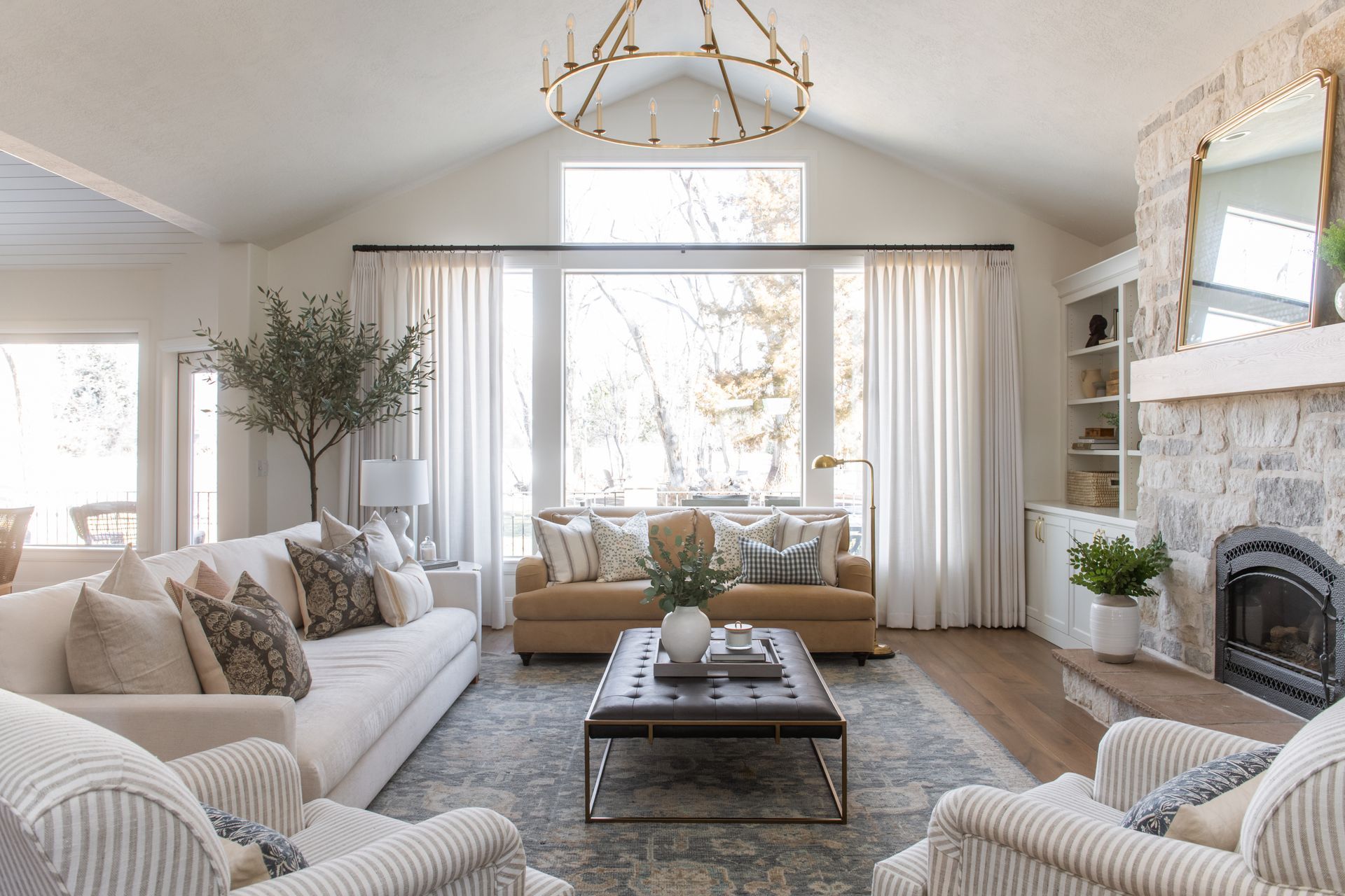 Custom drapery and natural light filtering window treatments in luxury living room