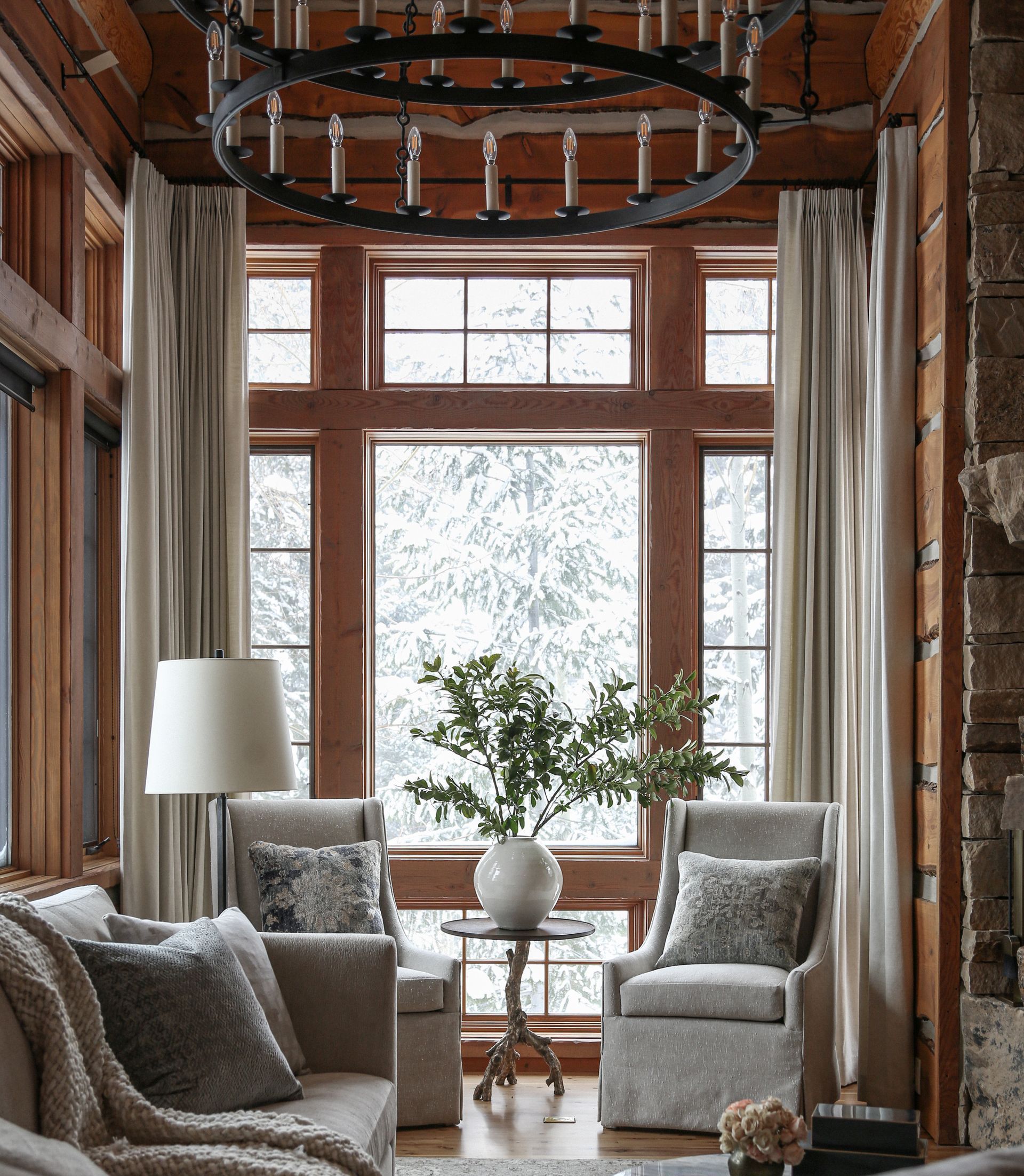Custom drapery for floor-to-ceiling windows in mountain lodge great room